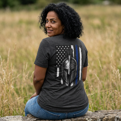 Woman in a dark grey heather Spartan thin blue line shirt, back view with a Spartan helmet over a blue line flag